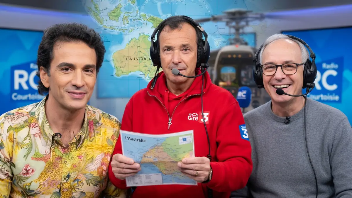 Marc Bessou tient une carte de l'Australie entre deux hommes portant un casque