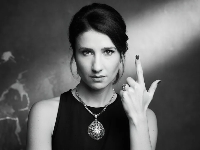 Marie S'infiltre regarde l'objectif tout en levant son majeur dans ce portrait en noir et blanc