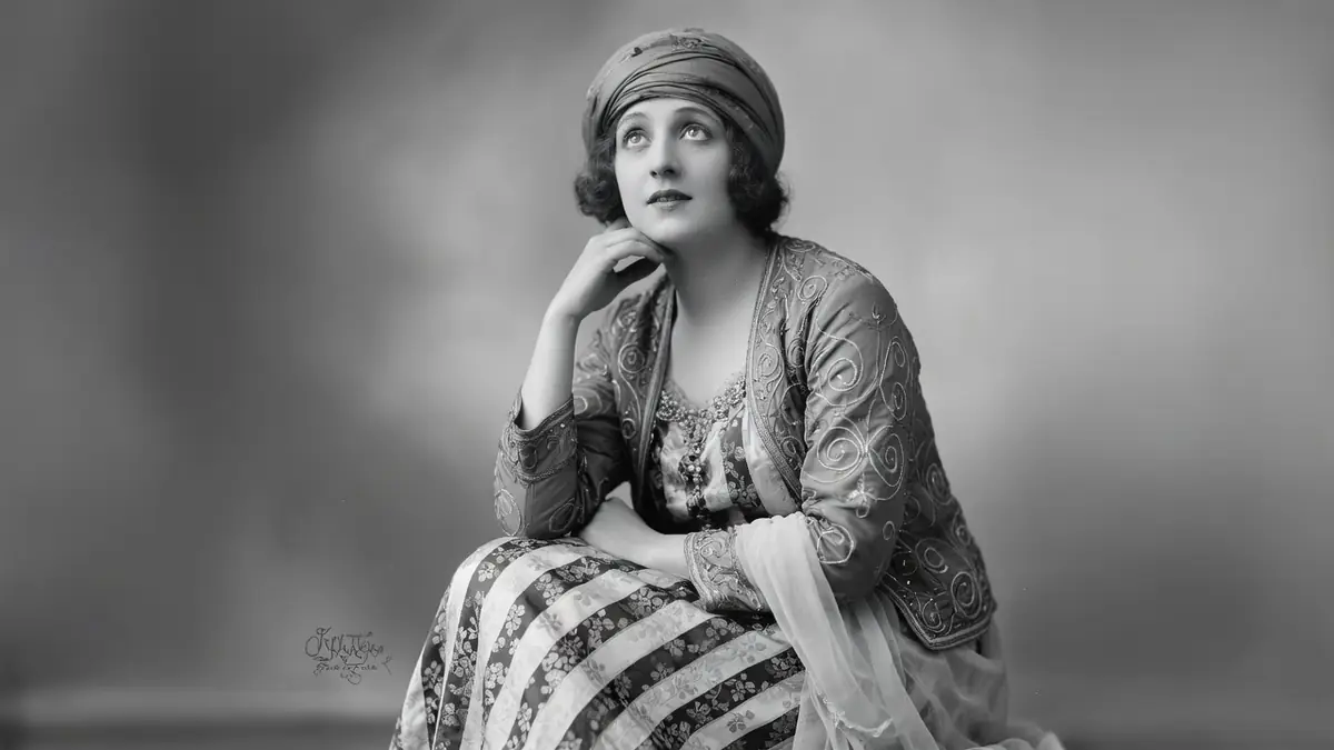Charlotte Lysès est assise la main près du visage dans ce portrait en noir et blanc