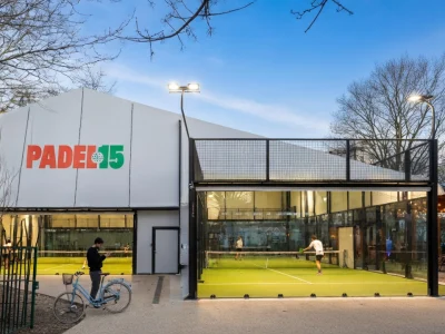 Vue extérieure du complexe sportif padel 15 avec des terrains de jeu modernes éclairés et une terrasse conviviale