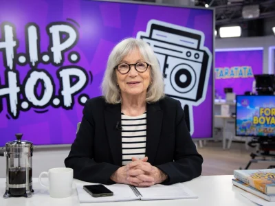Marie-France Brière est assise à un bureau dans un plateau de télévision