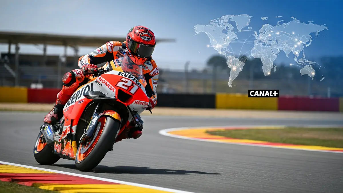 Un pilote moto penché dans un virage sur le circuit pour horaire GP Moto