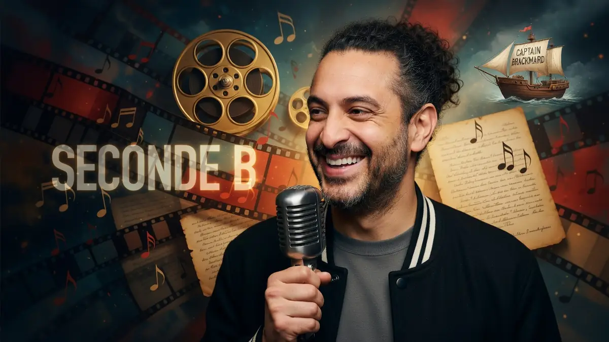 Pascal Jaubert sourit en tenant un micro vintage sur un fond artistique coloré