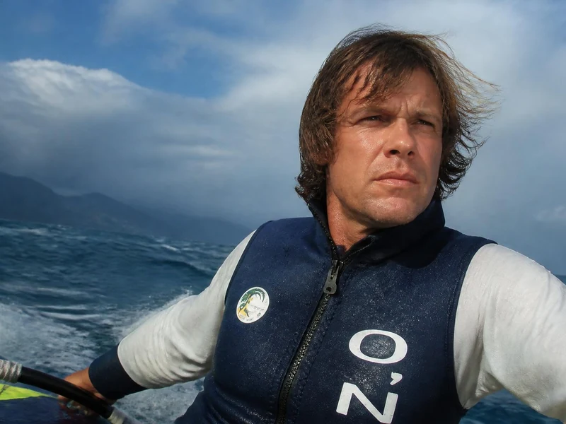 Portrait d'Arnaud de Rosnay en pleine navigation sur l'océan lors d'une expédition en planche à voile