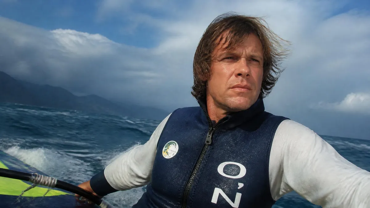 Portrait d'Arnaud de Rosnay en pleine navigation sur l'océan lors d'une expédition en planche à voile